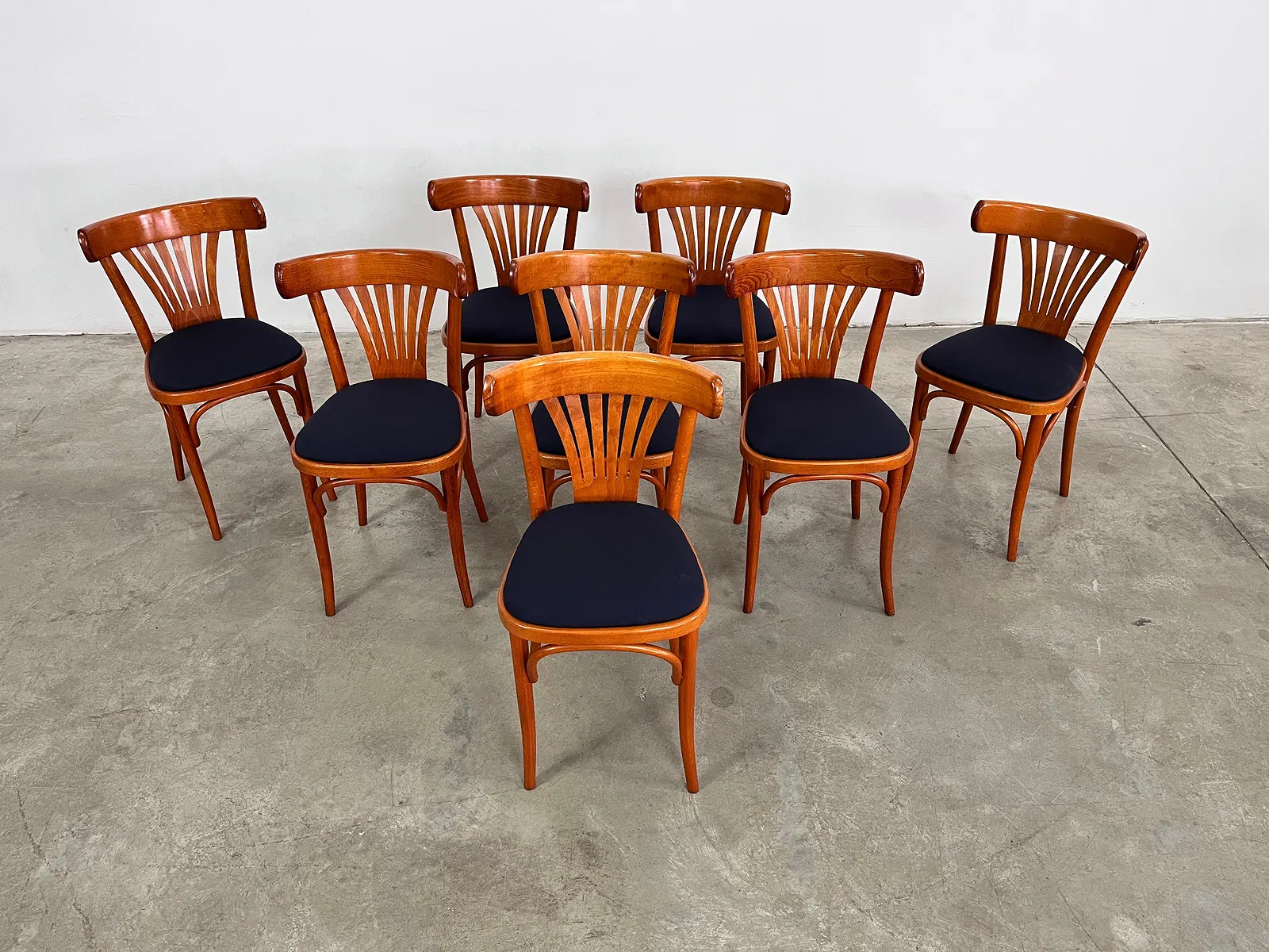 Bistro Chairs in Cherry with upholstered blue seats.
