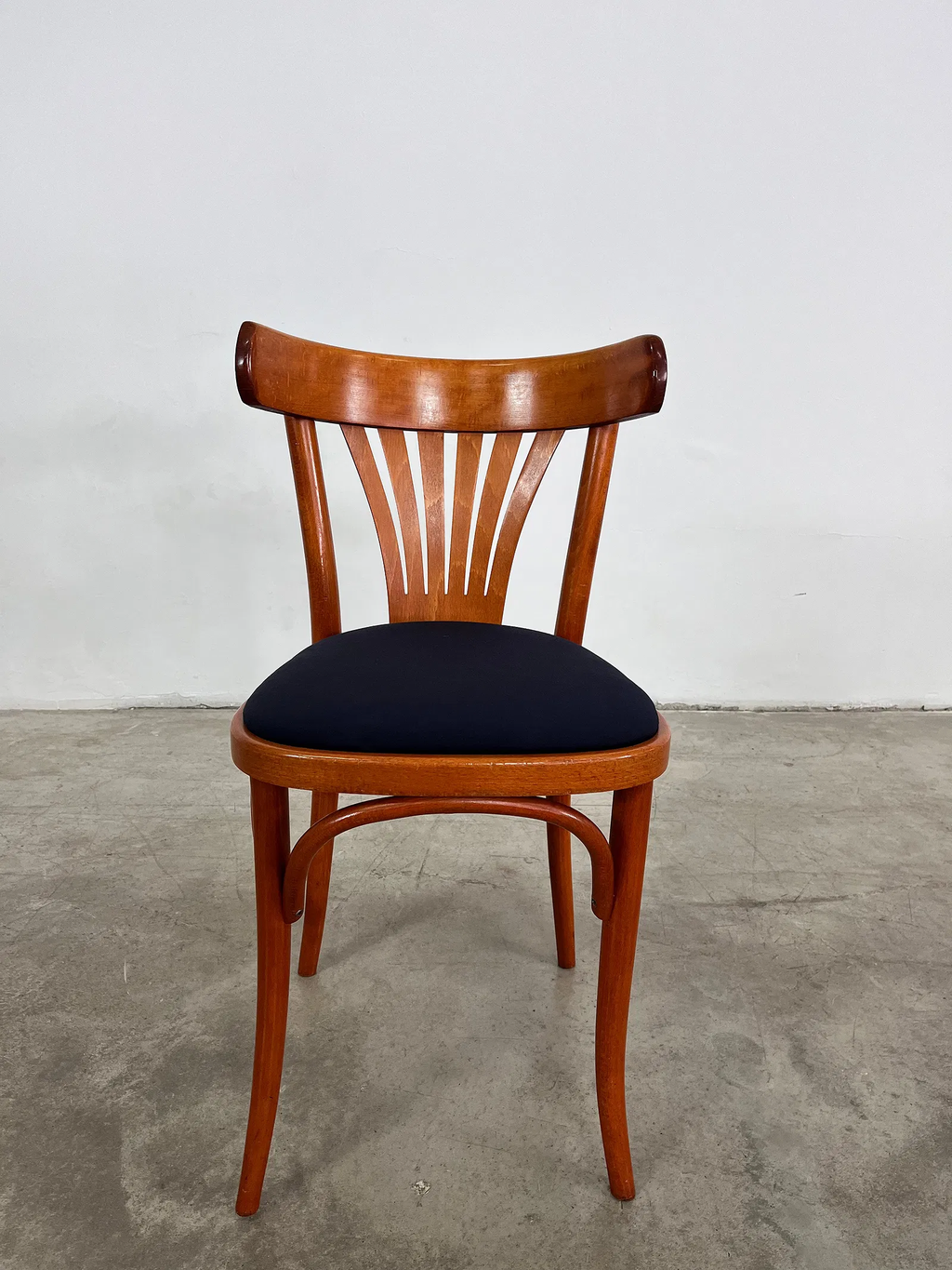 Bistro Chairs in Cherry with upholstered blue seats.